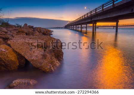 sunset in the sea and transport bridge