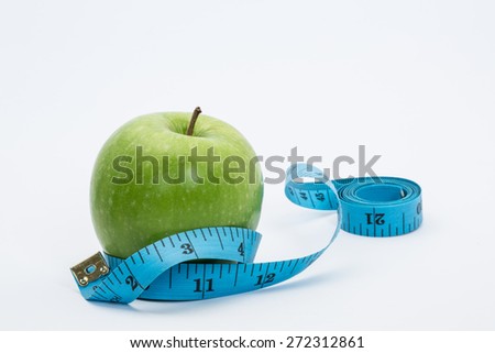 stock image of the green apple and measuring tape