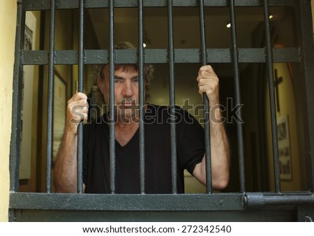 Convicted felon in jail Royalty-Free Stock Photo #272342540