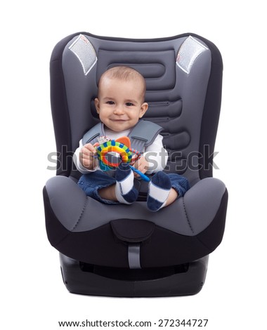 Adorable little kid sitting in a car seat, isolated