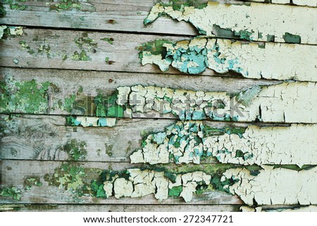 Peeling paint on old wooden wall