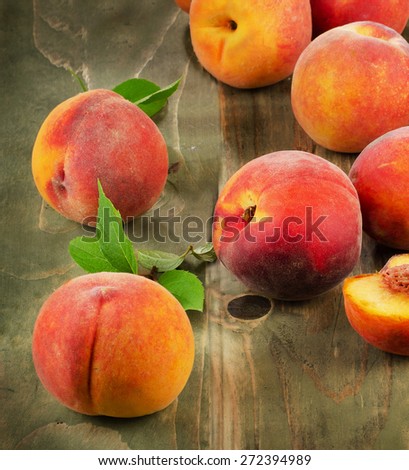 Fresh peaches on a wooden table. Selective focus