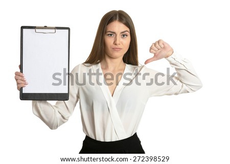 Beautiful woman with clipboard and thumb down sign on white background
