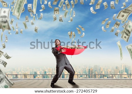 Businessman surrounded with money