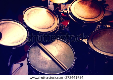 Drums conceptual image. Picture of drums and drumsticks lying on snare drum. Retro vintage picture.