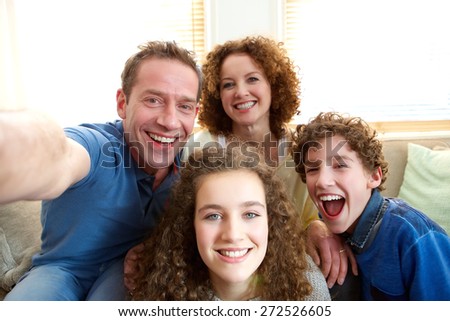 Portrait of a happy family taking a selfie at home