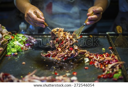 Chinese Chef making Iron Squid. Located in old town of Lijiang, Yunnan Province, China. Royalty-Free Stock Photo #272546054
