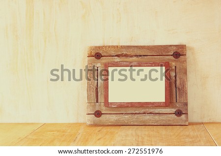 photo of old nautical wooden frame on wooden table 