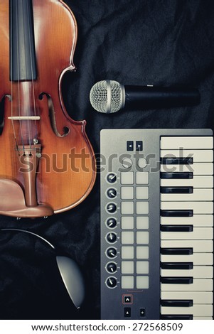 classical violin, keyboard, headphone, dynamic microphone on black fabric, vintage filter for music background