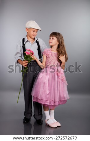 The boy gives a flower to the girl. Photo in retro style.