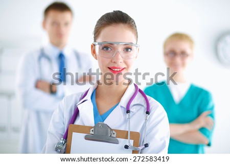 Woman doctor standing with folder at hospital 