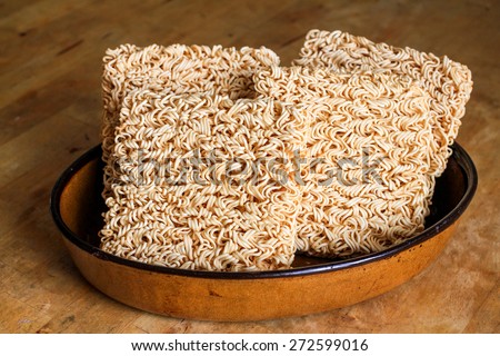 Four packs of instant noodle in brown ceramic plate