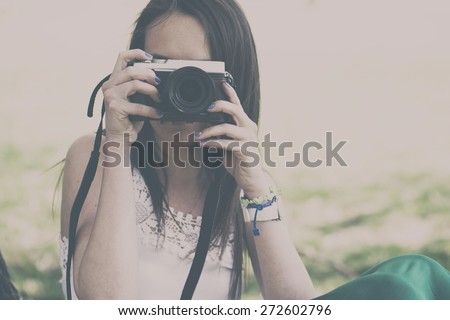 Woman with a retro camera. Analog effected photo.