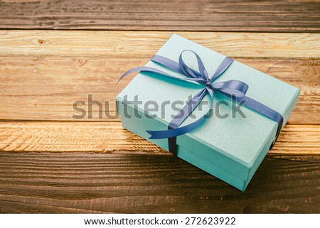 Gift box on wooden background - vintage effect