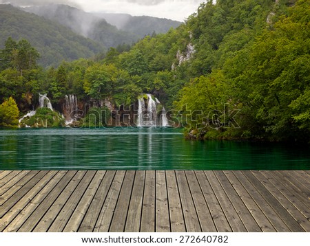 Waterfall in Plitvice lake and wooden plank, Croatia.