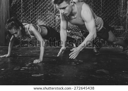 Sportsmen. fit male trainer man and woman doing clapping push-ups explosive strength training concept crossfit fitness workout strenght power. Royalty-Free Stock Photo #272645438
