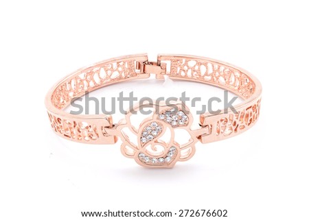 gold bracelet with a flower on a white background