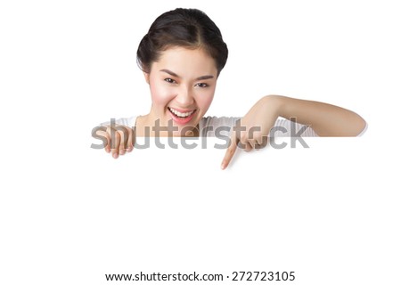 Young smiley Asian woman showing and pointing at blank billboard sign banner isolated on white background.