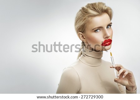 Exaggerated injection to the lips of a beautiful blonde Royalty-Free Stock Photo #272729300