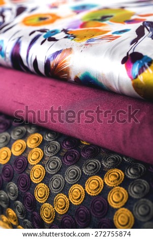 Rolls of colorful fabric as a vibrant background image.