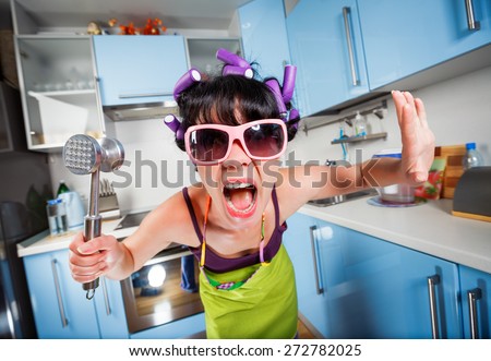 Crazy housewife in an interior of the kitchen. Family problems. Royalty-Free Stock Photo #272782025