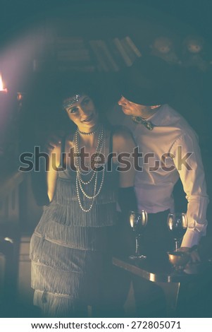 Retro couple.Couple with glasses of red wine in restaurant.Fashion,retro, vintage, tones.Retro couple.Couple with glasses of red wine in restaurant.Fashion,retro, vintage, tones. Antique picture .