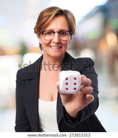portrait of a mature business woman holding a dice