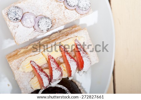 selection of fresh cream napoleon and chocolate mousse cake dessert plate 