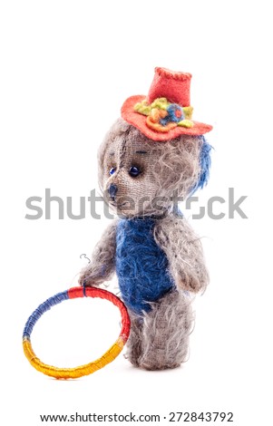 Vintage artistic Teddy Bear toy in clown's gown on white background. Image for children, holidays and entertainment. Funny colorful doll.