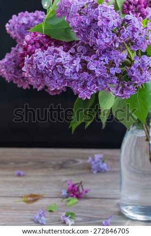 Fresh Lilac flowers  in glass vase on table