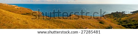 Sea beach with small rocky lagoon and coastal grass. Five shots composite picture.