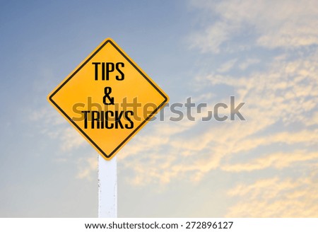Road sign indicating Tips and Tricks on blurred sky and cloud with sunlight background