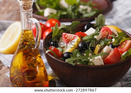 Delicious fresh salad with arugula, feta cheese and tomatoes close-up on a plate, horizontal 