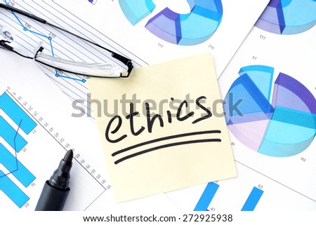 Papers with graphs, glasses and ethics business  concept.