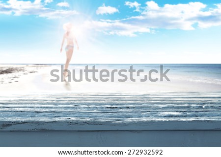 woman in blue bikini on beach and table 