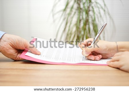 boss gives employee dismissal contract to sign Royalty-Free Stock Photo #272956238