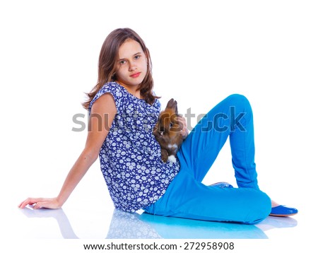 Easter concept image. Cute girl with adorable rabbit over isolated white background.