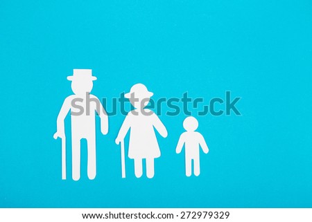 Cardboard figures of the family on a blue background. The symbol of unity and happiness.
