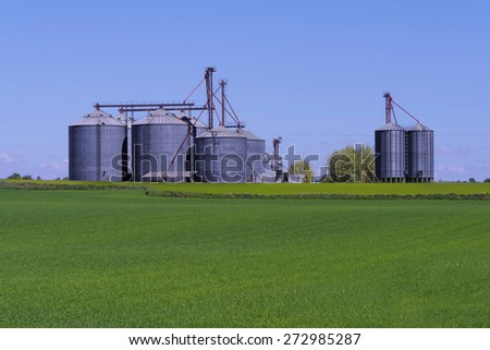 Grain bins with a crop field in front 