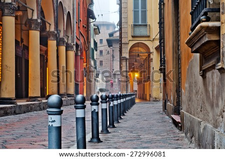 Old street view Bologna city, Italy. Cobble stone street with bollards. Renaissance buildings. Royalty-Free Stock Photo #272996081