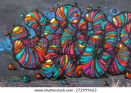 Beautiful street art graffiti. Abstract creative drawing fashion colors on the walls of the city. Urban Contemporary Culture Royalty-Free Stock Photo #272999663