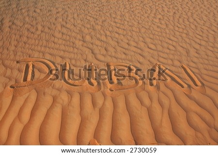 dubai written in desert sand