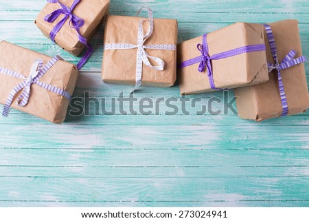 Many wrapped boxes with presents on turquoise painted wooden planks. Selective focus. Place for text. 