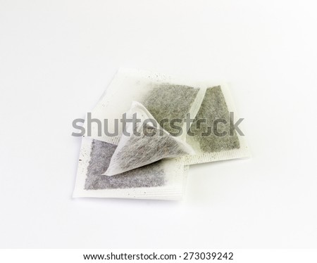 Bags of green and black tea on a white background
