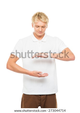 Young and handsome teenage boy with an imaginary, invisible and abstract object isolated on white
