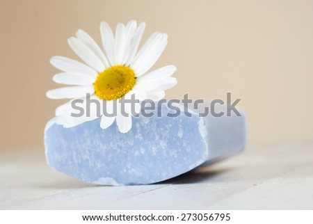 soap stack with chamomile flower on white wood table