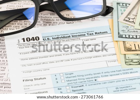 Tax form with glasses, and banknote taxation concept