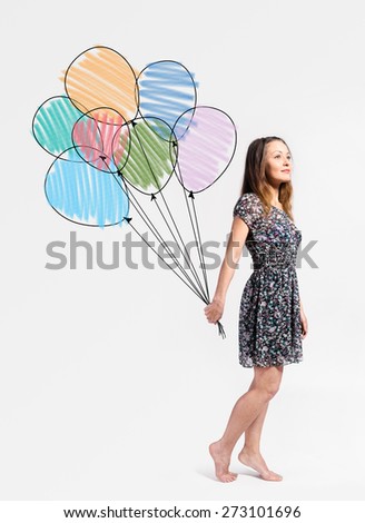 imagination. young woman is standing with drawn balloons