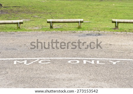 Designated parking area for motorcycles in a public park in the UK