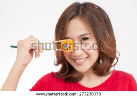 Close-up. young lady eating sushi roll